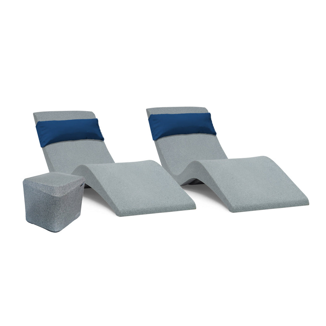 Two modern gray lounge chairs with blue cushions from AquaOutdoors rest beside a gray cube-shaped table. The Pool Lounge Chair Set showcases a minimalist design, ideal for poolside relaxation or on a tanning shelf with an Aqua Bundle.