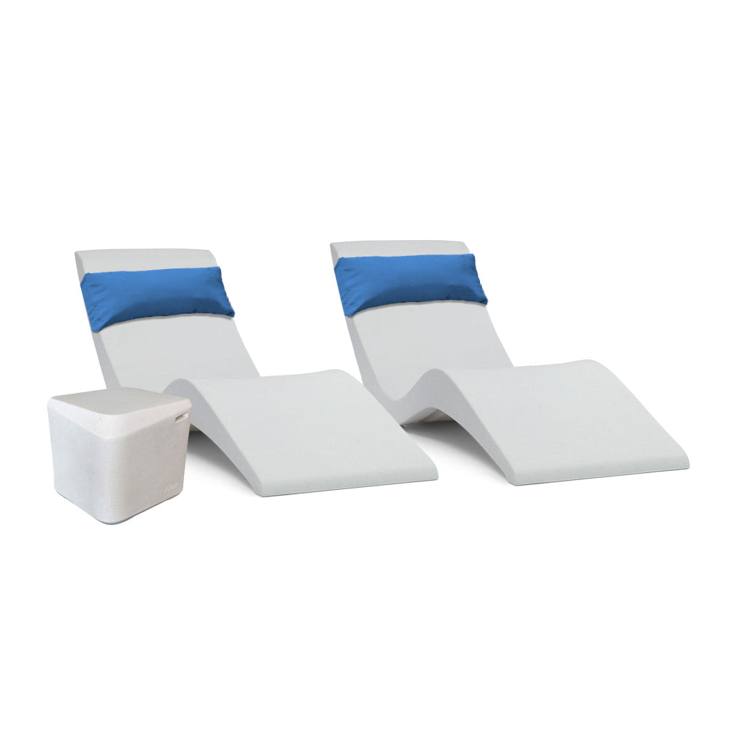 The AquaOutdoors Pool Lounge Chair Set features two modern, white, wave-like chaise loungers with blue cushions and a small white cube-shaped side table, elegantly set against a plain white background, perfect for a tanning shelf or contemporary space.