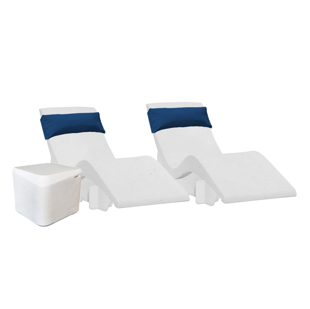 The Chaise Deep Ledge Bundle by AquaOutdoors features two white, curvy chaise loungers with blue headrests and a small square side table, all set against a plain white background to highlight their modern design, creating an inviting space for relaxation or enjoying the Deep Aqua Bundle ambiance.