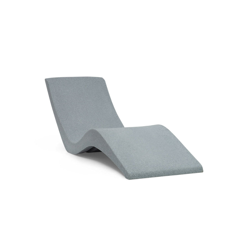 The AquaOutdoors Chaise Pool Lounger is a modern, minimalist gray chair with a wave-like design crafted from solid surface material, offering a sleek and contemporary appearance.