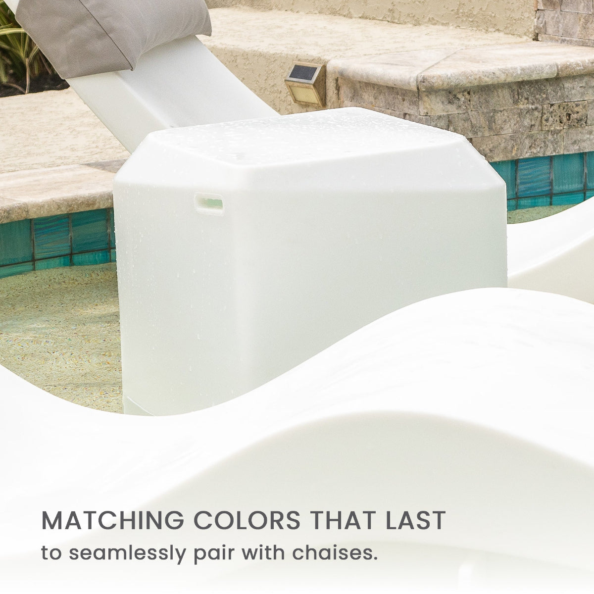 White chaise lounges partially submerged in a pool, accompanied by a matching rectangular side table. Text at the bottom reads, Matching colors that last to seamlessly pair with chaises.