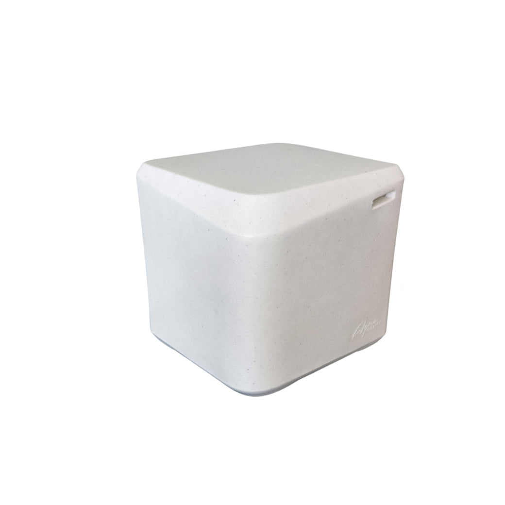A small, light gray, minimalist cube-shaped AquaOutdoors In Pool Table with smooth, rounded edges and a subtle groove on one side. Its matte finish complements any space, making it versatile enough to blend effortlessly into a pool lounge area.