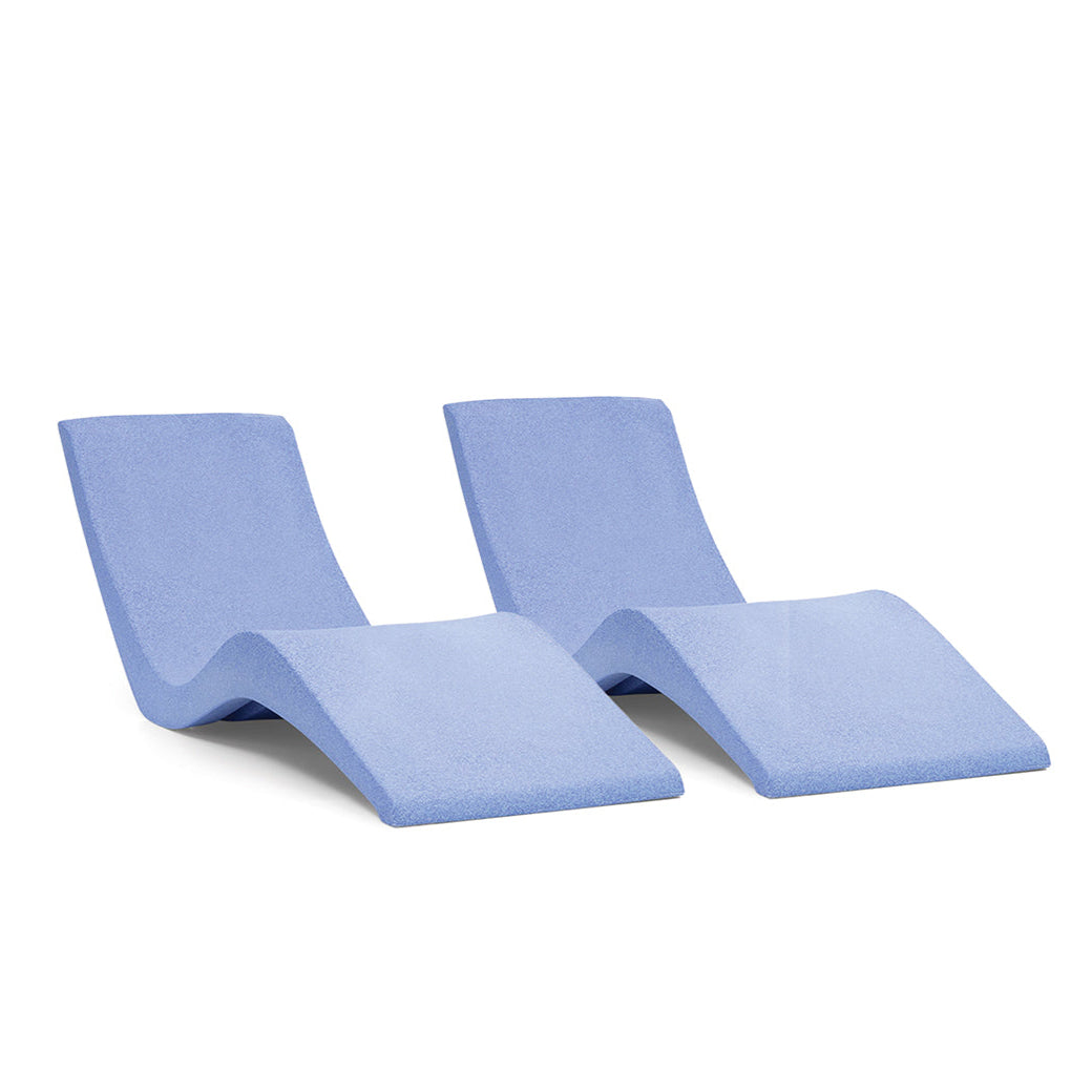 The AquaOutdoors Chaise Lounge Set includes two modern, blue chaise lounges with a curved, minimalist design made from solid surface materials. Their wave-like structure is ideal for poolside relaxation and adjusting to preferred water depths.