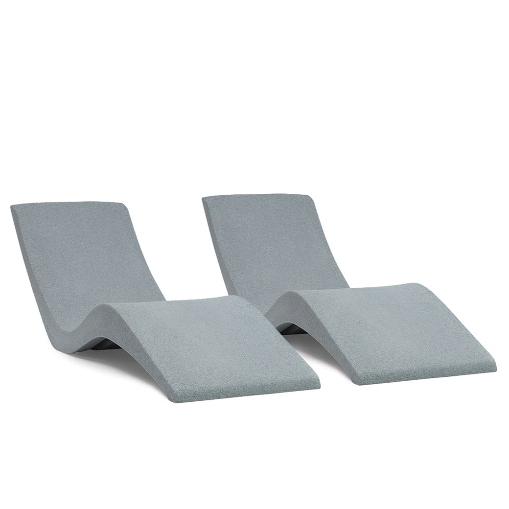 AquaOutdoors Chaise Lounge Set features two sleek, modern gray chairs with a wavy design, styled side by side for a smooth and contemporary aesthetic that invites relaxation.