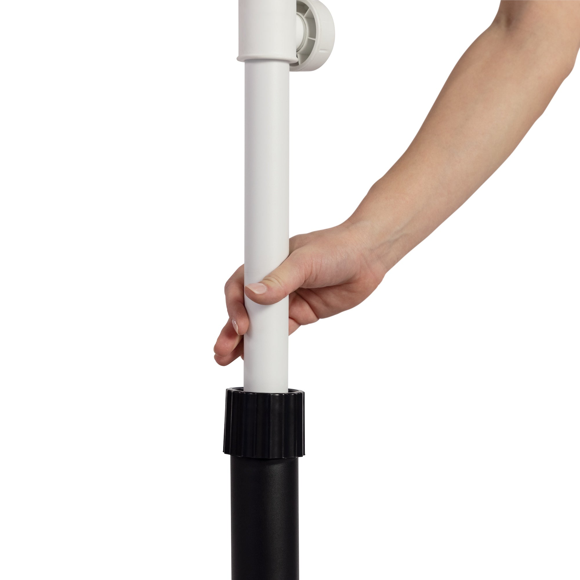 A hand adjusts the height on an Aqua Outdoors Patio Umbrella Base using a black adjustable collar, fitting 1.5 and 2 poles. The sleek black and white design of the pole highlights its extendability, providing stable support in your outdoor space.