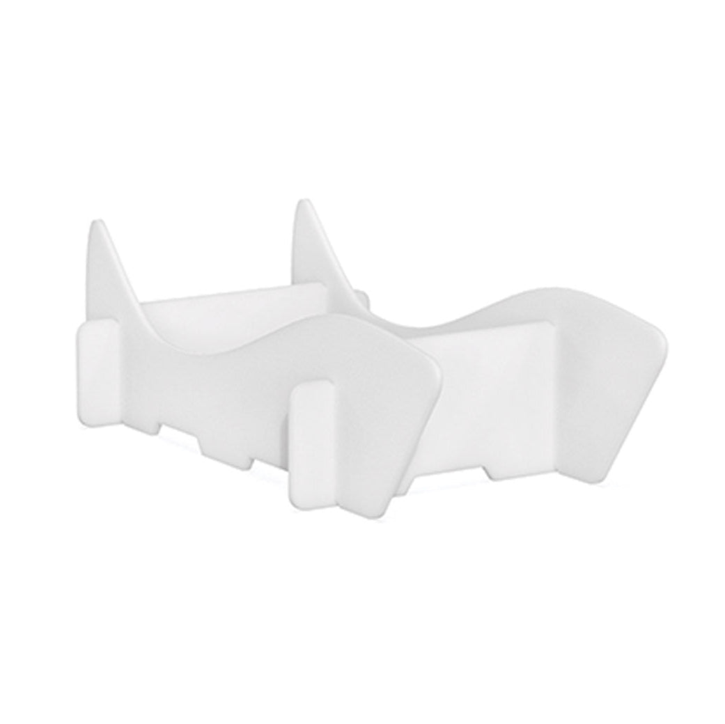 The AquaOutdoors Chaise Riser is a white plastic stand with curved supports resembling an in-pool lounge chair. Its minimalist, modern design includes a base and two side supports to hold devices or objects upright against a plain white background.